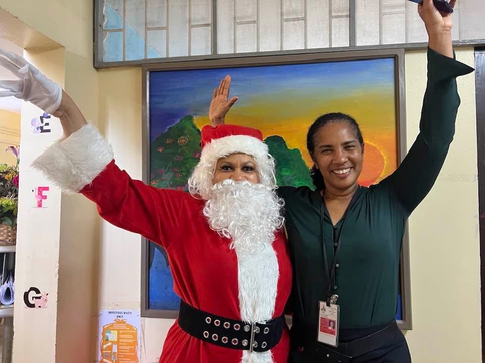 Santa and a community member celebrating together