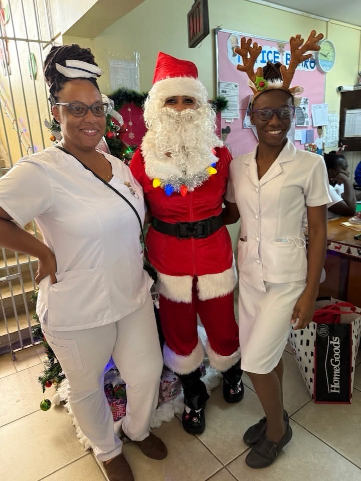Santa celebrating with two community members